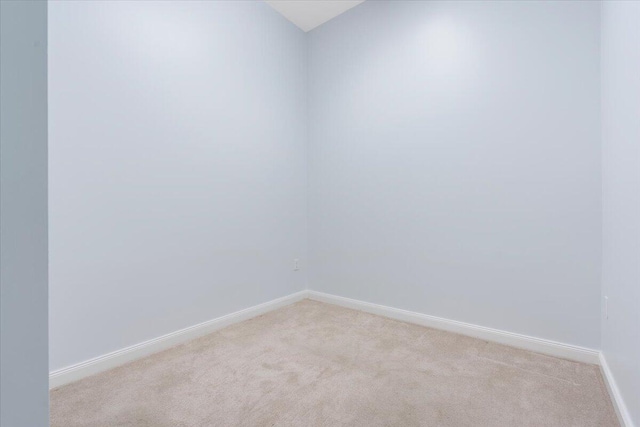 unfurnished room featuring light colored carpet