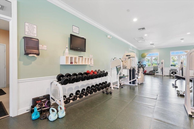 workout area featuring crown molding