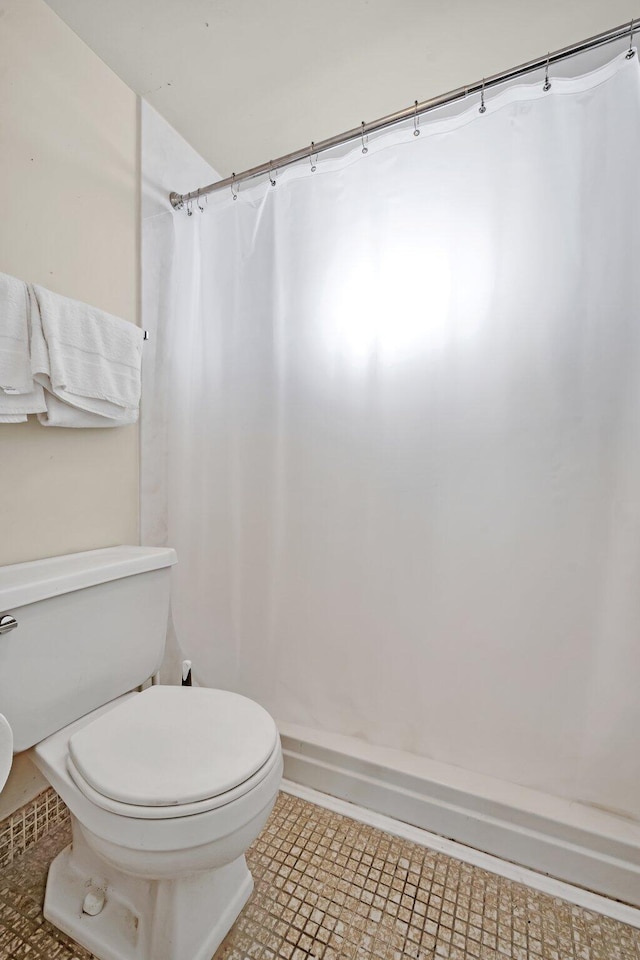 bathroom featuring tile patterned flooring and toilet