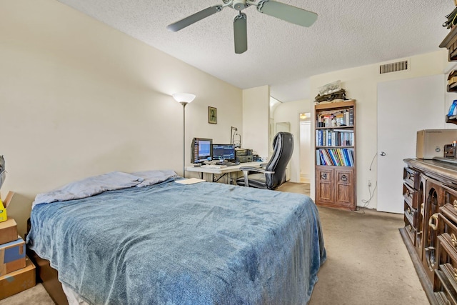 bedroom featuring ceiling fan, light colored carpet, and a textured ceiling