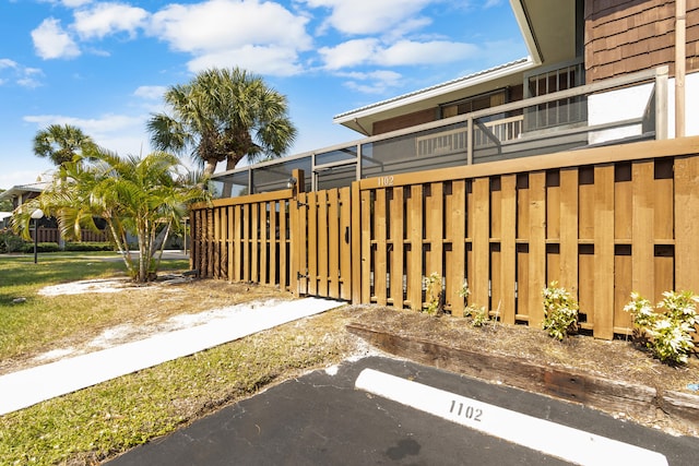 view of yard with a balcony and fence