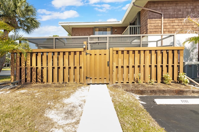 view of yard featuring a gate, central AC, and fence