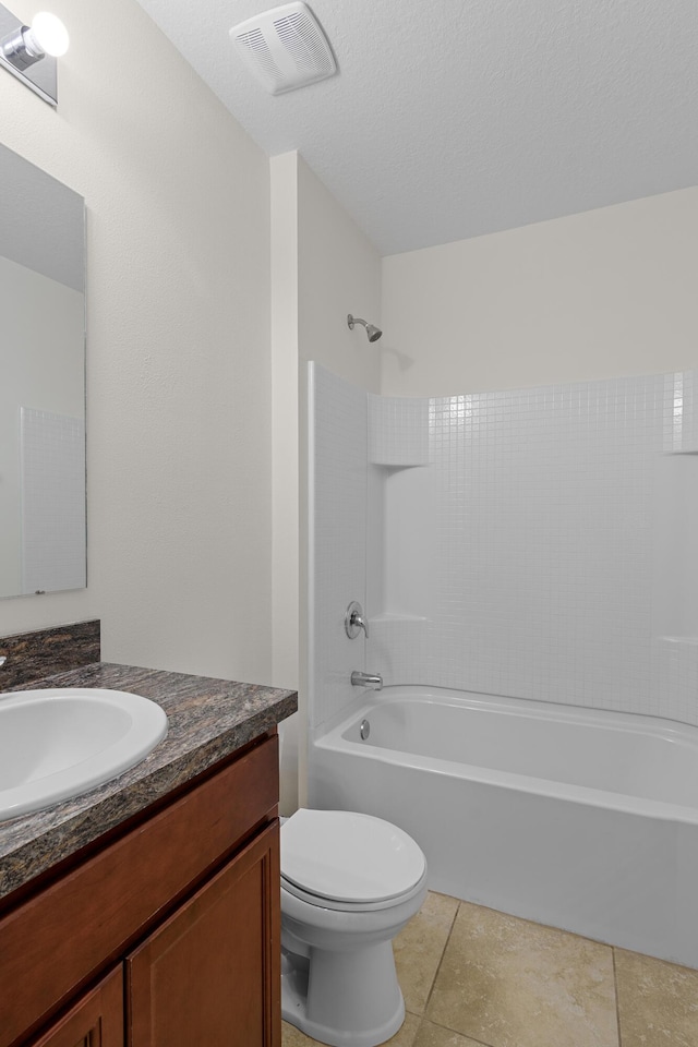 full bathroom with bathtub / shower combination, vanity, a textured ceiling, tile patterned flooring, and toilet