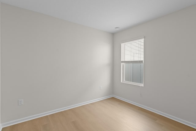 spare room with hardwood / wood-style flooring