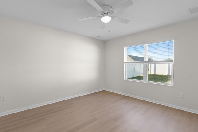 empty room with ceiling fan and light wood-type flooring