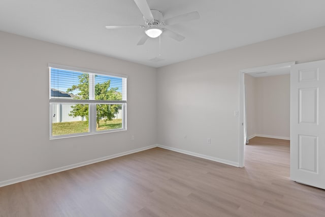 spare room featuring ceiling fan and light wood-type flooring