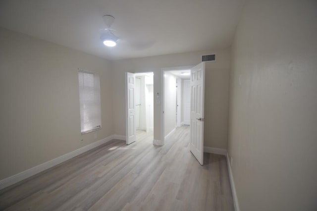 unfurnished room with light wood-type flooring