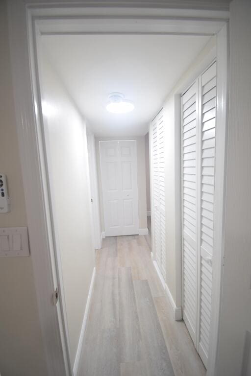 hallway with light hardwood / wood-style flooring