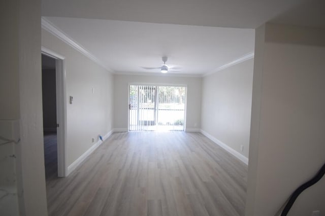 empty room featuring ceiling fan, light hardwood / wood-style floors, and ornamental molding