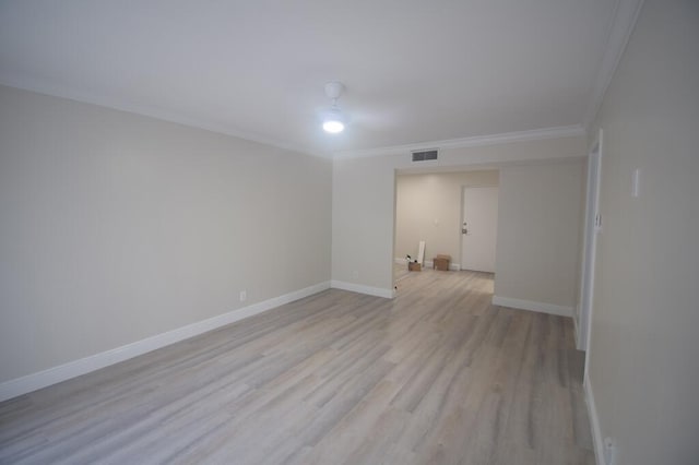 empty room with light hardwood / wood-style floors and ornamental molding