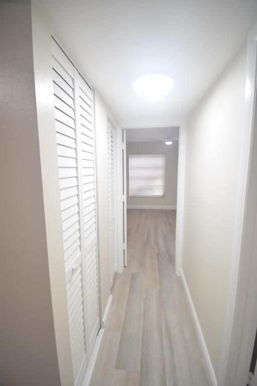 hallway with light hardwood / wood-style flooring