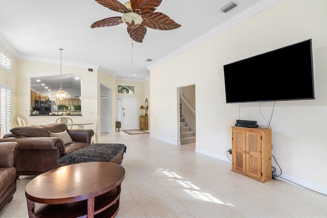 living room with ceiling fan and ornamental molding