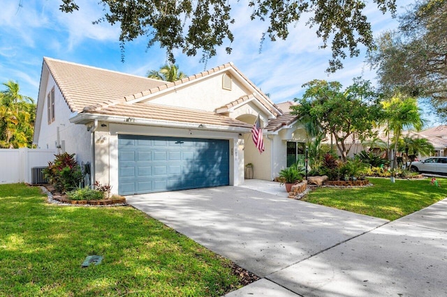 view of front of house featuring a front lawn, cooling unit, and a garage