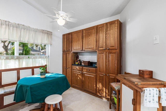 kitchen with ceiling fan and a textured ceiling