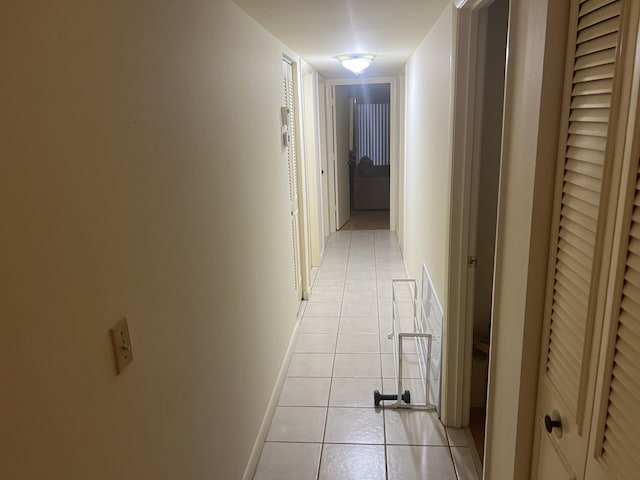 hall with light tile patterned floors