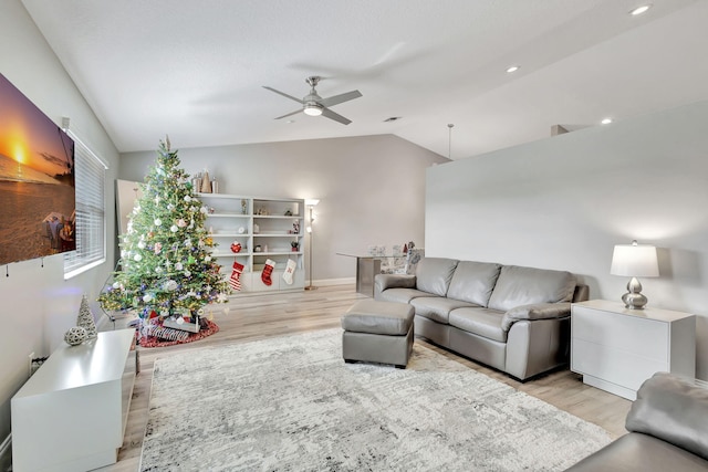 living room featuring light wood-type flooring, ceiling fan, and lofted ceiling