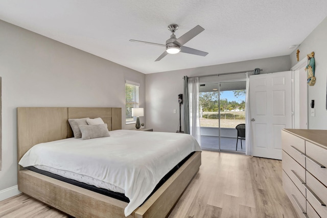 bedroom featuring access to outside, ceiling fan, light hardwood / wood-style floors, and a textured ceiling