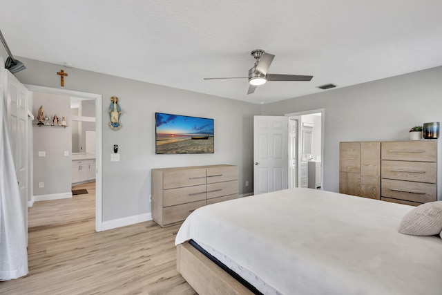 bedroom with connected bathroom, light hardwood / wood-style floors, and ceiling fan