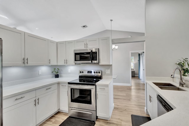 kitchen featuring white cabinetry, sink, stainless steel appliances, light hardwood / wood-style flooring, and lofted ceiling