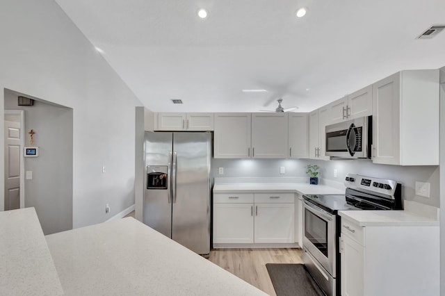 kitchen featuring ceiling fan, light wood-type flooring, white cabinetry, and appliances with stainless steel finishes