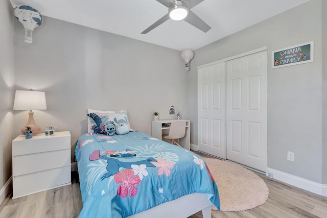 bedroom with ceiling fan, a closet, and light hardwood / wood-style flooring