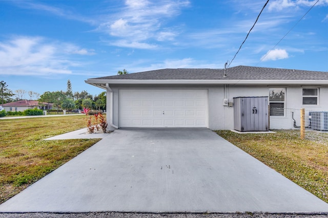 exterior space featuring central air condition unit, a garage, and a lawn