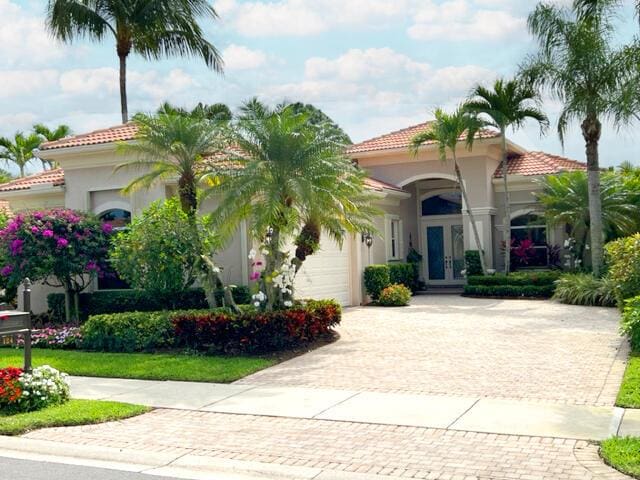 mediterranean / spanish-style house with french doors and a garage