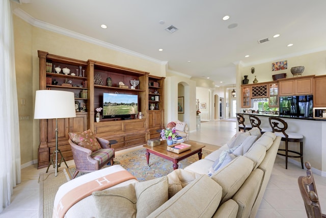 living room featuring light tile patterned flooring and ornamental molding