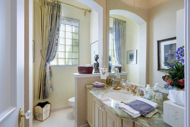 bathroom with vanity, tile patterned floors, and toilet