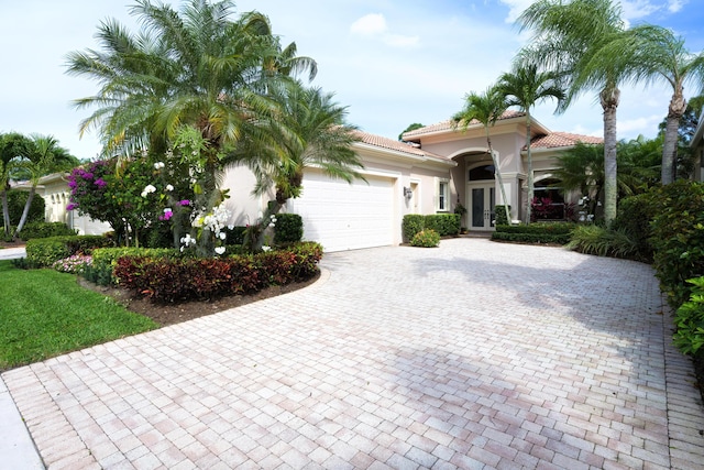 mediterranean / spanish-style house with a garage