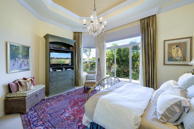 bedroom with a raised ceiling, crown molding, carpet flooring, and a chandelier