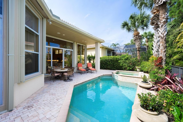 view of swimming pool with an in ground hot tub and a patio