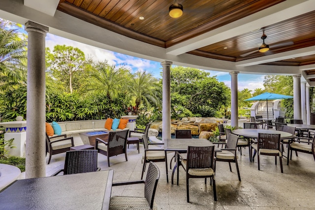 view of patio with an outdoor living space with a fire pit and ceiling fan