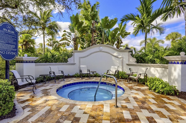 view of swimming pool with a community hot tub and a patio area