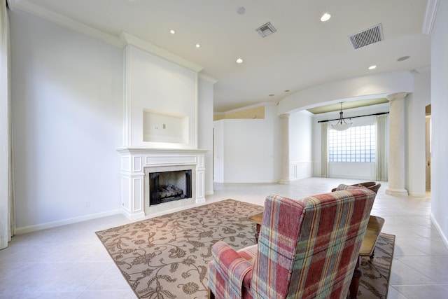 tiled living room with decorative columns and crown molding