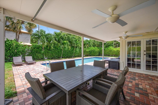 view of patio featuring ceiling fan, a fenced in pool, and french doors