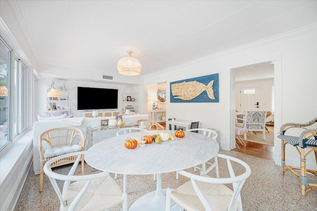 dining room with hardwood / wood-style flooring and ornamental molding