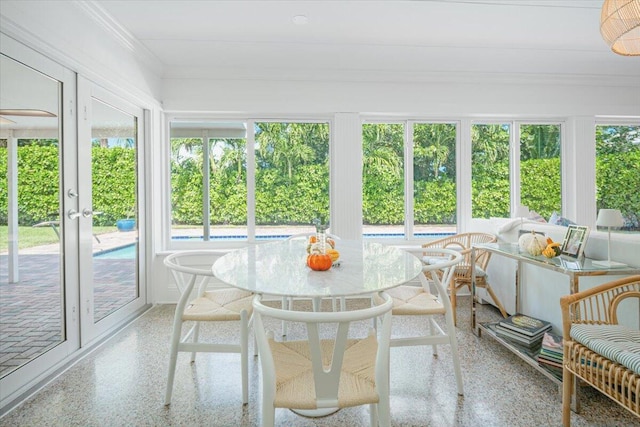 sunroom / solarium featuring french doors and plenty of natural light