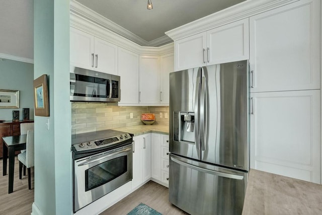 kitchen featuring white cabinets, stainless steel appliances, and light hardwood / wood-style floors