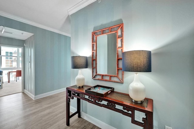 hallway with hardwood / wood-style floors and ornamental molding