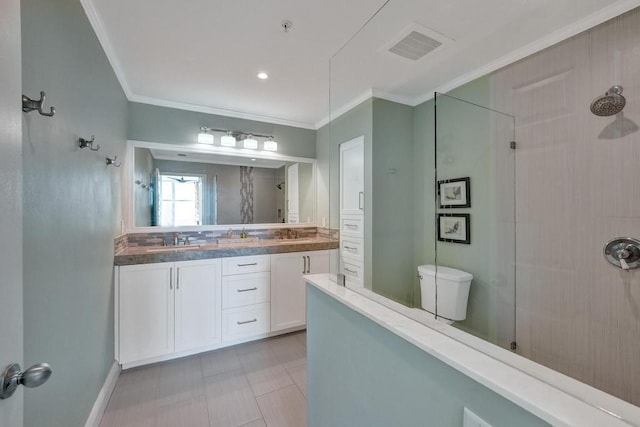 bathroom with vanity, toilet, tiled shower, and crown molding