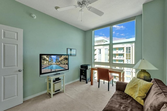 living room featuring a wealth of natural light, ceiling fan, and light colored carpet