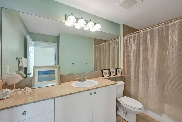 bathroom with tile patterned floors, vanity, and toilet