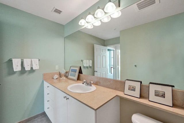 bathroom featuring vanity and toilet