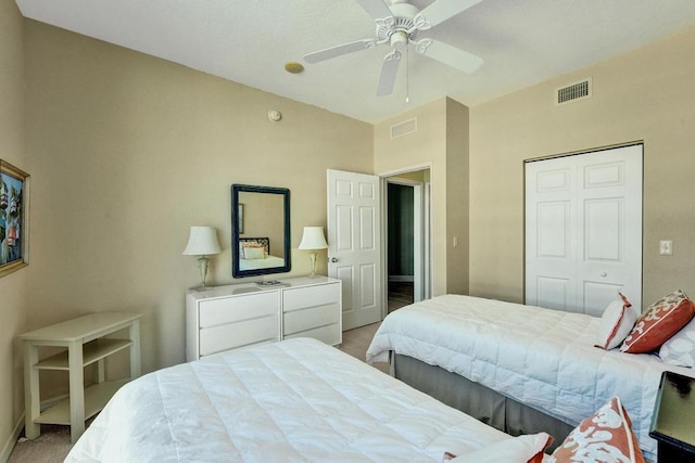 carpeted bedroom with a closet and ceiling fan