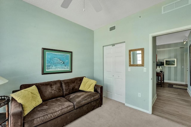 living room featuring ceiling fan and light colored carpet