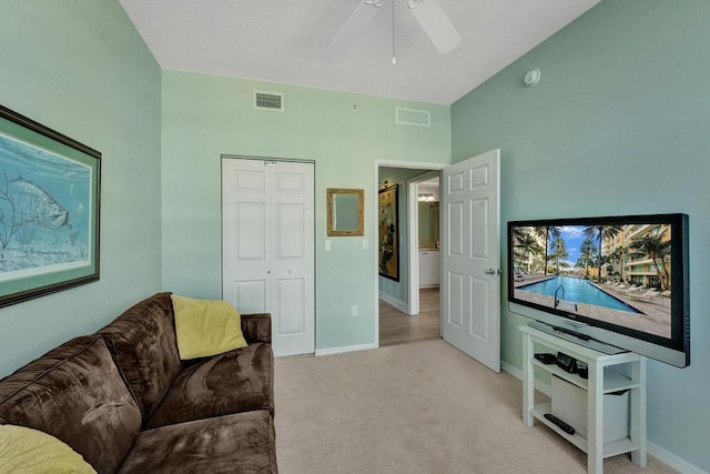 living room with ceiling fan and light colored carpet