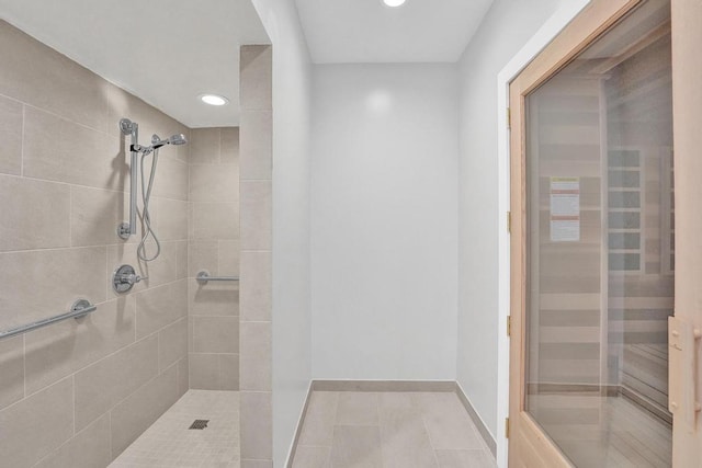 bathroom featuring tile patterned floors and tiled shower