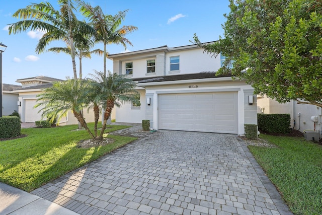 front of property featuring a front lawn and central AC unit