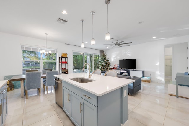 kitchen with visible vents, dishwasher, gray cabinets, light countertops, and a sink